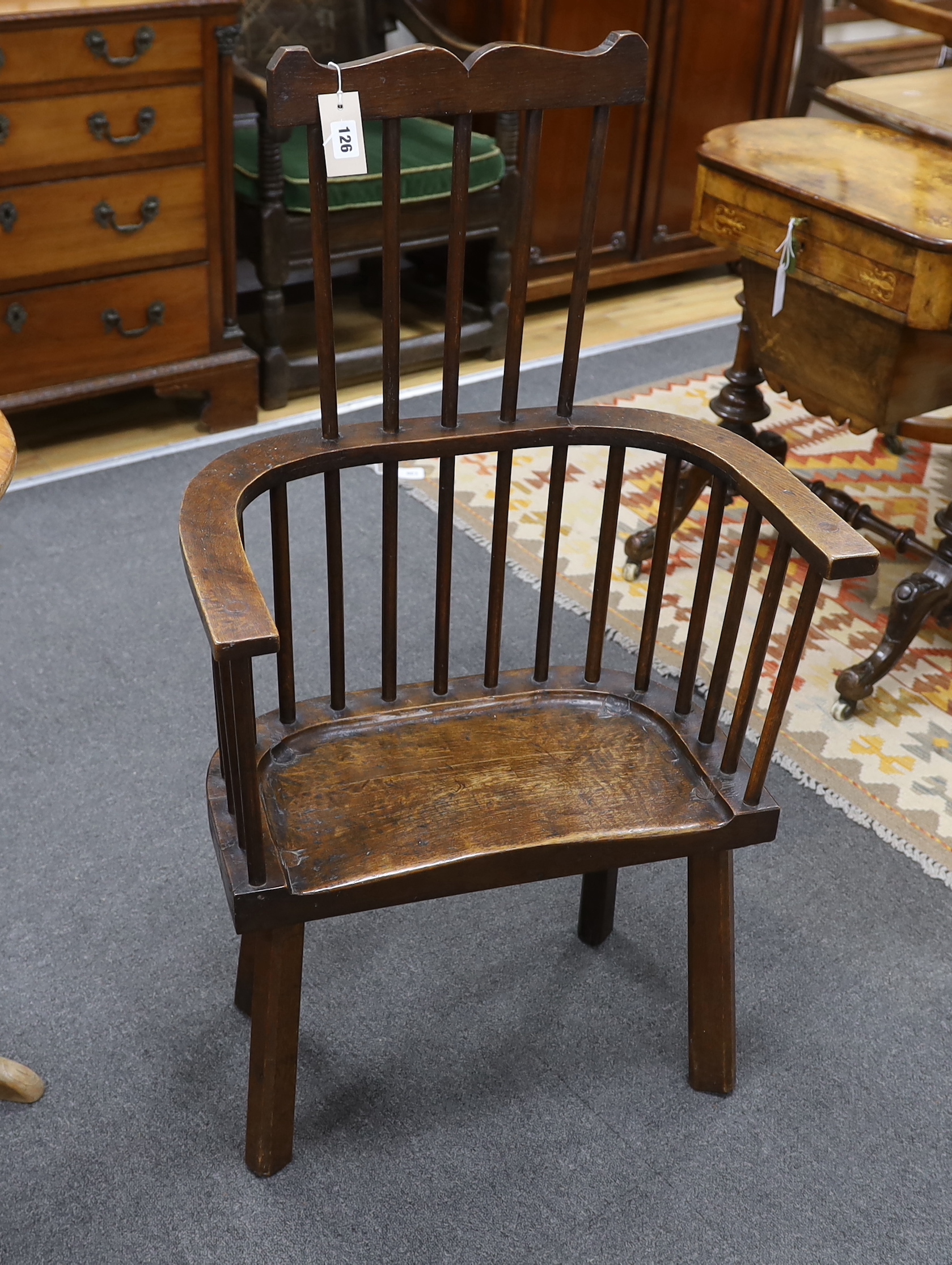 An 18th century-style primitive oak Windsor armchair believed to have been constructed from oak timbers salvaged from re-roofing works at Winchester Cathedral, width 59cm, depth 30cm, height 104cm